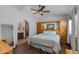 Spacious bedroom featuring a ceiling fan, wood floors, and built-in wooden cabinets for ample storage at 6031 E Inglewood St, Mesa, AZ 85205