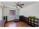 Bedroom featuring a ceiling fan and wood floors, perfect for a home gym at 6031 E Inglewood St, Mesa, AZ 85205