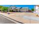 A view of the home's exterior, featuring a spacious driveway at 6031 E Inglewood St, Mesa, AZ 85205