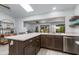 Updated kitchen with white countertops, stainless steel dishwasher, modern fixtures, and view to the dining room at 6031 E Inglewood St, Mesa, AZ 85205