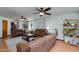 Living room features leather couches, ceiling fans, neutral paint, and views to the outside at 6031 E Inglewood St, Mesa, AZ 85205
