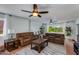 Bright and airy living room with three leather sofas, tile flooring, ceiling fan, and lots of windows at 6031 E Inglewood St, Mesa, AZ 85205
