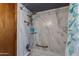 Shower with nice shower head, grab bar, and leafy patterned shower curtain at 6031 E Inglewood St, Mesa, AZ 85205
