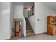 Staircase with carpet, neutral paint, and railings, leads to the basement with view to a downstairs bathroom at 6031 E Inglewood St, Mesa, AZ 85205