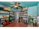 Large storage room with red floors, blue walls, and shelves full of storage containers and boxes at 6031 E Inglewood St, Mesa, AZ 85205