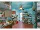 Spacious storage room with shelves and storage bins, painted in blue with a ceiling fan at 6031 E Inglewood St, Mesa, AZ 85205