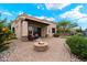 Backyard with brick patio, fire pit, and manicured landscaping, perfect for outdoor gatherings at 6202 E Mckellips Rd # 65, Mesa, AZ 85215