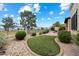 Serene backyard featuring artificial turf, a rock garden, and a view of the golf course beyond the iron fence at 6202 E Mckellips Rd # 65, Mesa, AZ 85215