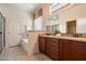 Bathroom with dual sinks, granite countertops, a separate shower, and tub with tile surround at 6202 E Mckellips Rd # 65, Mesa, AZ 85215