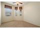 This bedroom is carpeted and has windows with blinds and curtains that let in natural light at 6202 E Mckellips Rd # 65, Mesa, AZ 85215