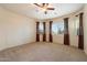 Spacious bedroom with neutral carpet, lots of windows and natural light, and a ceiling fan at 6202 E Mckellips Rd # 65, Mesa, AZ 85215