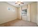 A carpeted bedroom with a ceiling fan, and a window bringing in natural light at 6202 E Mckellips Rd # 65, Mesa, AZ 85215