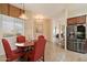 Dining area featuring a pendant light fixture, window views, and access to kitchen and living spaces at 6202 E Mckellips Rd # 65, Mesa, AZ 85215
