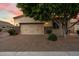 Exterior of a home with brick driveway, a neutral garage door, and mature landscaping and shade tree at 6202 E Mckellips Rd # 65, Mesa, AZ 85215
