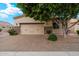Attached two-car garage with a paved driveway and mature shade tree in front yard at 6202 E Mckellips Rd # 65, Mesa, AZ 85215