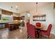 Kitchen and dining area with island, stainless appliances, and stylish decor and dark wood cabinets at 6202 E Mckellips Rd # 65, Mesa, AZ 85215