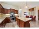 This kitchen boasts dark wood cabinets, granite countertops, and stainless steel appliances at 6202 E Mckellips Rd # 65, Mesa, AZ 85215