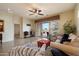 Open concept living room showcasing tile floors, comfortable seating, and a sliding door to the backyard at 6202 E Mckellips Rd # 65, Mesa, AZ 85215
