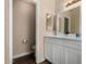 Clean half-bath featuring a large vanity with a white countertop and ample storage space at 6416 S 19Th Pl, Phoenix, AZ 85042