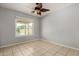 This bedroom features neutral paint and tiled floors and window with outside view at 6416 S 19Th Pl, Phoenix, AZ 85042