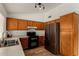 Well-lit kitchen with wood cabinets, stainless refrigerator, gas range, and plenty of counter space at 6416 S 19Th Pl, Phoenix, AZ 85042