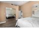 Bedroom featuring mirrored closet, ceiling fan, and warm paint tones at 6416 S 19Th Pl, Phoenix, AZ 85042