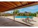 Back yard with a large in-ground swimming pool, lounge chairs, covered patio at 6416 S 19Th Pl, Phoenix, AZ 85042