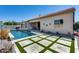 Backyard featuring a pool with a waterfall feature, travertine pavers and artificial turf at 8712 W Sequoia Dr, Peoria, AZ 85382