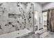 Modern bathroom featuring a stand up shower with decorative marble tiles and gray wood-style tile flooring at 8712 W Sequoia Dr, Peoria, AZ 85382