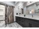 Bathroom with a double sink vanity with gray cabinets, white marble countertops and a decorative sliding barn door at 8712 W Sequoia Dr, Peoria, AZ 85382