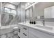 Elegant bathroom featuring double sinks, white marble counters, shower and decorative plants by a window at 8712 W Sequoia Dr, Peoria, AZ 85382
