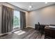 Bedroom features a ceiling fan, plank flooring, and a large window at 8712 W Sequoia Dr, Peoria, AZ 85382