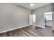 An airy bedroom with gray walls features a ceiling fan, walk-in closet, and doorway to a storage area at 8712 W Sequoia Dr, Peoria, AZ 85382