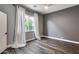 This cozy bedroom offers ample natural light through a large window and features modern gray walls at 8712 W Sequoia Dr, Peoria, AZ 85382