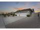 Well-maintained three-car garage with an expansive driveway and desert landscaping at 8712 W Sequoia Dr, Peoria, AZ 85382