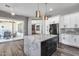 Kitchen with island, stainless steel appliances, white cabinets, and a view to outdoor living at 8712 W Sequoia Dr, Peoria, AZ 85382