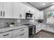 Kitchen area with marble countertops and backsplash with stainless steel appliances at 8712 W Sequoia Dr, Peoria, AZ 85382