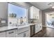 Kitchen features a farmhouse sink, marble countertops, and large bright window at 8712 W Sequoia Dr, Peoria, AZ 85382