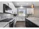 Bright kitchen featuring white cabinets, marble countertops, stainless steel appliances, and a farmhouse sink at 8712 W Sequoia Dr, Peoria, AZ 85382