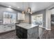 Kitchen with island, marble counters, stainless steel appliances, and sliding glass doors to outdoor living at 8712 W Sequoia Dr, Peoria, AZ 85382