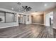 Bright living room with wood floors, recessed lighting, and a modern ceiling fan at 8712 W Sequoia Dr, Peoria, AZ 85382