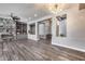 Open concept living room with fireplace, modern chandelier, and hardwood floors at 8712 W Sequoia Dr, Peoria, AZ 85382