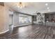 Bright living room with hardwood floors, a modern fireplace, and views of the pool at 8712 W Sequoia Dr, Peoria, AZ 85382