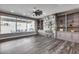 Spacious living room with built-in shelving, a fireplace, hardwood floors, and access to an outdoor area at 8712 W Sequoia Dr, Peoria, AZ 85382