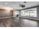 Spacious living room featuring hardwood floors and large window showcasing the outdoor pool and patio area at 8712 W Sequoia Dr, Peoria, AZ 85382