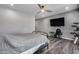 A spacious main bedroom features wood-look floors, ceiling fan, and a wall-mounted television at 8712 W Sequoia Dr, Peoria, AZ 85382