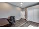 A spacious home office features a closet and leads to a storage room, with dark wood-look floors at 8712 W Sequoia Dr, Peoria, AZ 85382