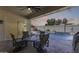 Relaxing covered patio area with outdoor seating overlooking a beautiful pool and landscaped yard at 8712 W Sequoia Dr, Peoria, AZ 85382
