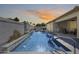 Sparkling pool with water feature surrounded by a patio and lush landscaping at 8712 W Sequoia Dr, Peoria, AZ 85382