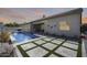 Beautiful pool with travertine tile, desert landscaping, and a covered patio at 8712 W Sequoia Dr, Peoria, AZ 85382